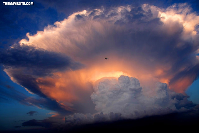 PlaneDwarfedBySummerClouds.jpg